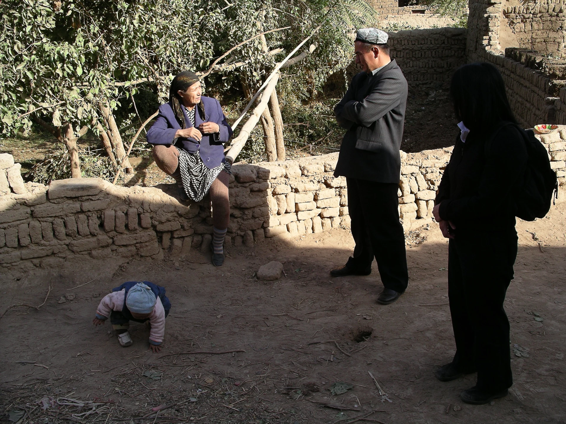 Uyghur family in Turpan — historical home-visit photograph (2005).